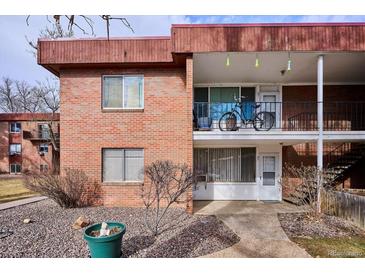 Brick building exterior featuring a balcony and bicycle at 10125 W 25Th Ave # 47, Lakewood, CO 80215