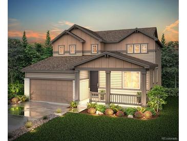 Beautiful two-story home with a charming front porch and well-manicured landscaping at 1713 Morgan Dr, Erie, CO 80516