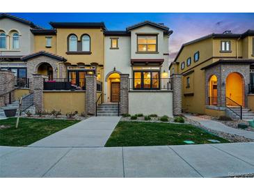 Inviting two-story home with well-manicured lawn and charming architectural details at 15628 W Baker Ave, Lakewood, CO 80228