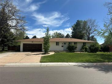 Charming single-story home with a well-maintained lawn and attached garage at 1836 E Mineral Ave, Centennial, CO 80122