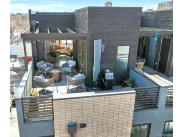 Inviting rooftop deck with outdoor seating, grill, and views into a cozy living space, perfect for entertaining at 2442 Champa St, Denver, CO 80205
