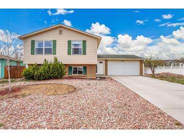Charming two-story home with a well-maintained yard, concrete driveway, and an attached two-car garage at 4309 S Coors Ct, Morrison, CO 80465