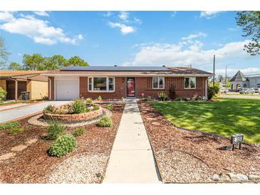 Charming brick home featuring a beautifully landscaped front yard and solar panels on the roof at 5593 E Center Ave, Denver, CO 80246