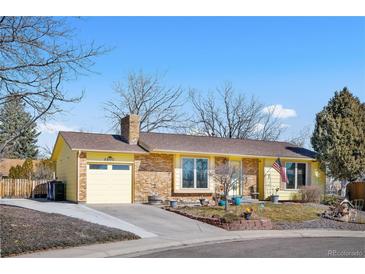 Charming ranch-style home with brick and siding, a well-maintained lawn, and an attached garage at 8612 S Everett Ct, Littleton, CO 80128