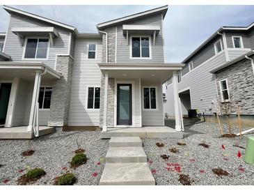 Stylish two-story home featuring stone accents, covered entrance, and contemporary design at 22813 E Tufts Ave # B, Aurora, CO 80015