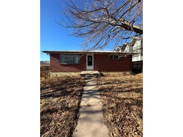 Charming brick home with a well-maintained front yard and walkway to the entrance at 1265 Yates St, Denver, CO 80204