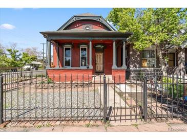 Charming red brick home with a covered front porch, stately columns, and a wrought-iron fence at 1103 Lipan St, Denver, CO 80204