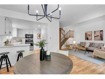 Open-concept living space with updated kitchen, dining area, and cozy living room with natural light at 4248 Corriente Pl, Boulder, CO 80301