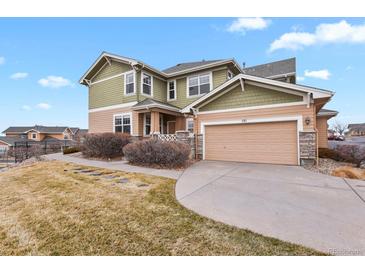 Charming home featuring a two-car garage, landscaped front yard, and inviting exterior at 3672 S Perth Cir # 101, Aurora, CO 80013