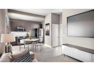 Modern kitchen with stainless steel appliances, sleek cabinetry, and eat-in dining area at 1643 Boulder St # 205, Denver, CO 80211
