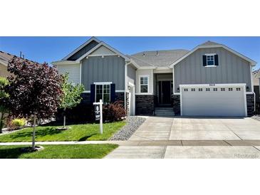 Charming two-story home boasts modern curb appeal with a well-manicured lawn and inviting entryway at 9028 S Catawba St, Aurora, CO 80016