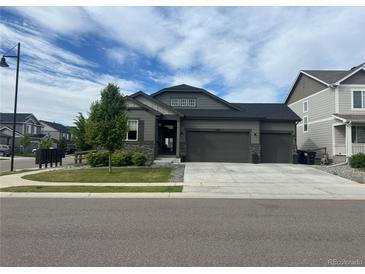Charming single-Gathering home with a three-car garage, manicured lawn, and tasteful stone accents at 5204 Lake Port Ave, Longmont, CO 80504