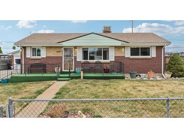 Charming brick home with a cozy front porch and well-maintained front lawn at 3540 E 90Th Pl, Thornton, CO 80229