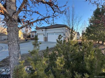 Beautiful single-story home with a three-car garage and manicured landscaping at 4971 Bross Pl, Broomfield, CO 80023