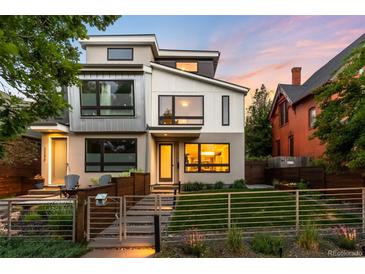 Modern two-story home with sleek lines, large windows, and landscaped front yard at 2242 W 34Th Ave, Denver, CO 80211