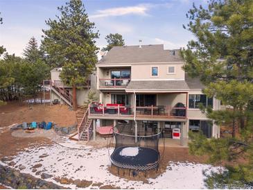 Luxury home with expansive deck, trampoline, and mountain views at 3028 Olympia Cir, Evergreen, CO 80439