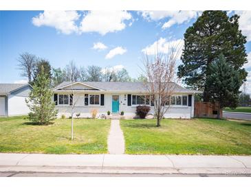 Charming ranch-style home with a well-maintained lawn and inviting turquoise front door at 986 S Jersey St, Denver, CO 80224