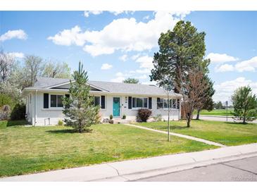 Charming ranch-style home with a well-maintained lawn and inviting turquoise front door at 986 S Jersey St, Denver, CO 80224