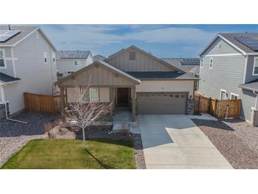 Charming single-Gathering home featuring a covered porch, two-car garage, and well-maintained landscaping at 915 N Waterloo Ct, Aurora, CO 80018