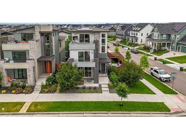 Stunning three-story home featuring modern architecture and landscaping for great curb appeal at 9391 E 59Th North Pl, Denver, CO 80238