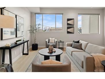 Bright living room with modern furnishings, decor, and a large window providing natural light at 4733 E Iliff Ave, Denver, CO 80222