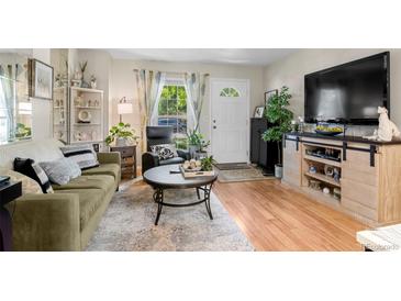 Cozy living room featuring a sofa, coffee table, and large TV at 1811 S Quebec Way # 134, Denver, CO 80231