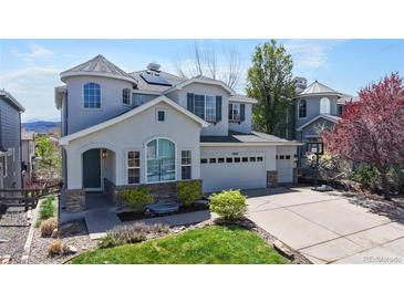 Beautiful two-story home with a two car garage, manicured lawn, and lovely curb appeal at 9804 N Crystal Lake Dr, Littleton, CO 80125