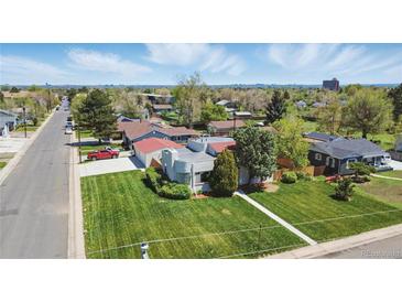 Aerial view of a charming home with a well-kept lawn, mature trees, and easy access to nearby streets at 1400 S Knox Ct, Denver, CO 80219