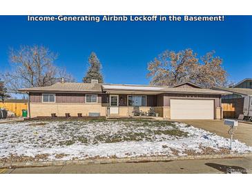 Ranch style home with a snow covered front yard, attached garage, and welcoming porch at 4481 W 89Th Way, Westminster, CO 80031