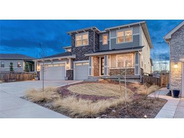 Stunning two-story home featuring stone accents, a two-car garage, and an inviting front yard at 2957 Eagle Wing Way, Castle Rock, CO 80109