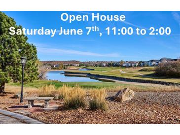 Picture inviting viewers to an open house, showcasing scenic golf course community with serene lake view and beautifully landscaped grounds at 1913 Five Iron Dr, Castle Rock, CO 80104