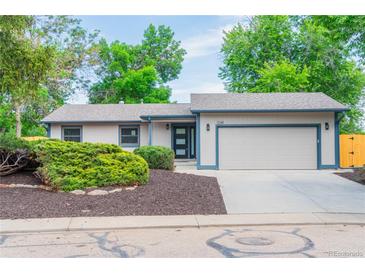 Charming single-story home with a two-car garage, complemented by lush landscaping and a well-maintained yard at 1248 Ilium Dr, Lafayette, CO 80026