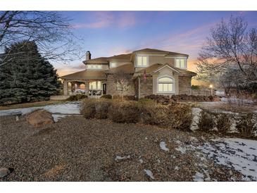 Two-story house with stone accents and a large front yard at 7285 Sagebrush Dr, Parker, CO 80138