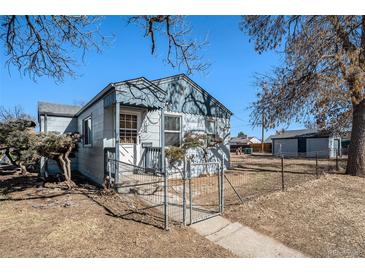 Charming single-story home with a fenced front yard and a small covered porch at 1200 Newark St, Aurora, CO 80010