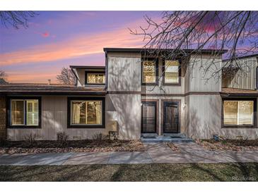 Charming townhouse showcasing a well-maintained exterior with two front doors and sunset backdrop at 3593 S Kittredge St # E, Aurora, CO 80013