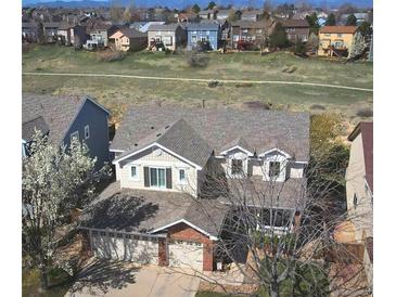 Two-story home showing a three-car garage and beautiful exterior and landscaping at 10259 Fairgate Way, Highlands Ranch, CO 80126