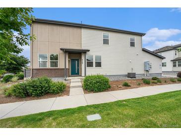 Charming two-story home with well-maintained lawn and inviting front entrance, showcasing modern design at 4760 Kittredge St, Denver, CO 80239