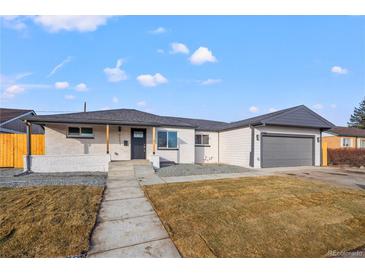 Charming home featuring a well-maintained yard, painted brick, and a gray two-car garage at 2341 Poze Blvd, Thornton, CO 80229