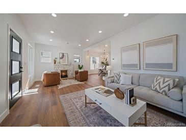 Bright, open living room with modern decor, fireplace, and hardwood floors at 3315 N Josephine St, Denver, CO 80205