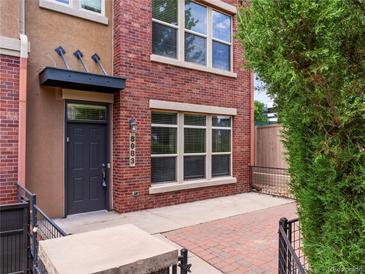 Charming brick townhome featuring a private entrance with stylish black door and inviting curb appeal at 8983 E Nichols Pl, Centennial, CO 80112