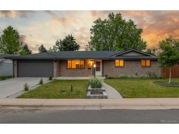 Charming brick home featuring a well-maintained lawn and an attached two-car garage at 2644 S Krameria St, Denver, CO 80222