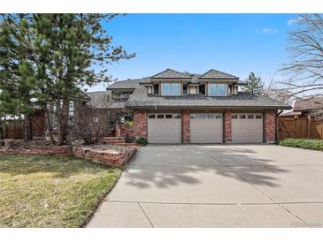 Lovely brick home with a three car garage and beautifully manicured lawn at 5797 S Laredo Ct, Centennial, CO 80015
