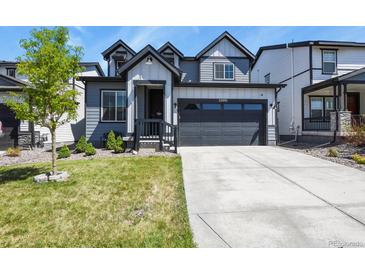 Charming two-story home featuring a modern design, well-manicured lawn, and a spacious two-car garage at 27893 E 6Th Pl, Aurora, CO 80018