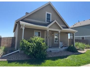 Charming single Gathering home features a cozy front porch and well-maintained landscaping at 2874 Rose Hill St, Strasburg, CO 80136