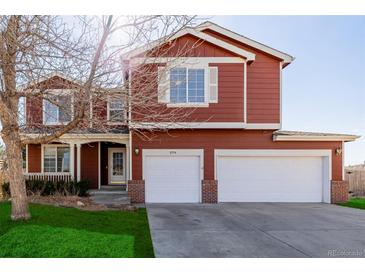 Charming two-story home with a well-maintained lawn and a spacious two car garage at 2954 E 108Th Dr, Northglenn, CO 80233