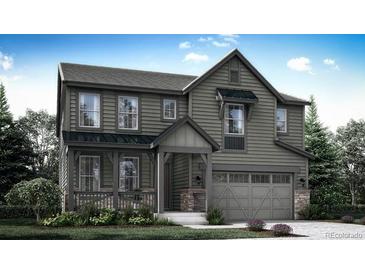 Beautiful two-story home featuring gray siding and a covered front porch at 7438 S Yank Ct, Littleton, CO 80127