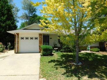 Ranch style home with attached garage and mature landscaping at 2991 S Whiting Way, Denver, CO 80231