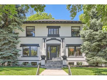 Charming home with black trim, stone stairs, and lush landscaping at 785 Fillmore St, Denver, CO 80206