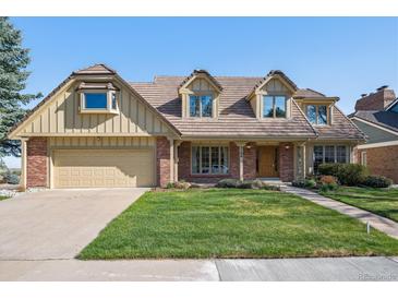Charming two-story home with a well-manicured lawn and attached two car garage at 5106 S Kenton Way, Greenwood Village, CO 80111