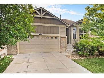 Charming home featuring a two-car garage, brick accents, and well-maintained landscaping at 5613 S Elk Ct, Aurora, CO 80016